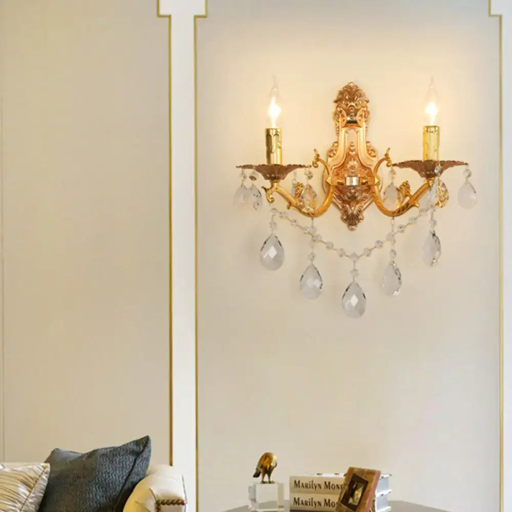 Gold crystal candelabra sconce by Decorbites with two candle bulbs and hanging crystal drops on Tampa Home & Garden Store