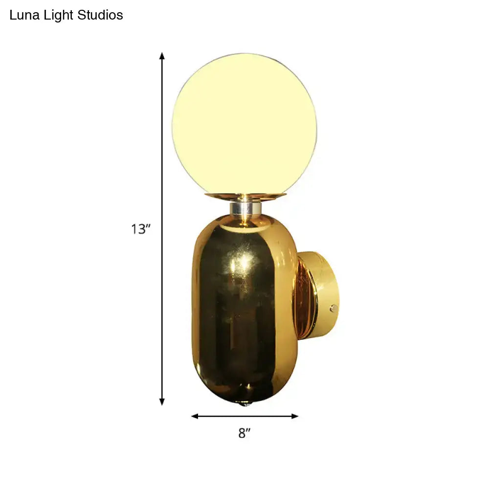 Gold glass globe wall sconce with brass body by Decorbites on Tampa Home & Garden Store