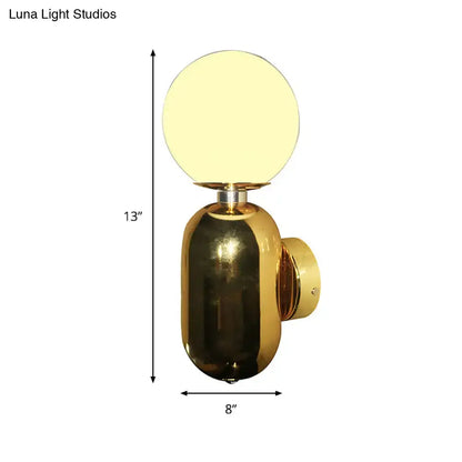 Gold glass globe wall sconce with brass body by Decorbites on Tampa Home & Garden Store
