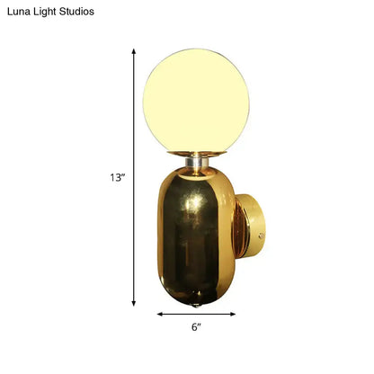 Gold glass globe sconce with brass finish backplate, 13in tall and 6in wide Decorbites on Tampa Home & Garden Store