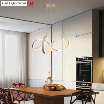Pendant light with gold and white LED looping design over a wooden kitchen island Decorbites on Tampa Home & Garden Store