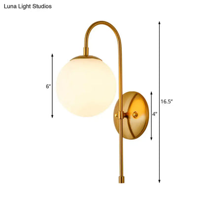 Gold gooseneck wall sconce with frosted glass globe and brass finish on Tampa Home & Garden Store