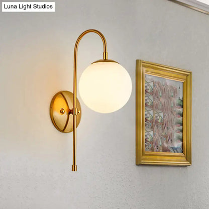 Gold gooseneck wall sconce by Decorbites with brass finish and frosted glass globe on Tampa Home & Garden Store