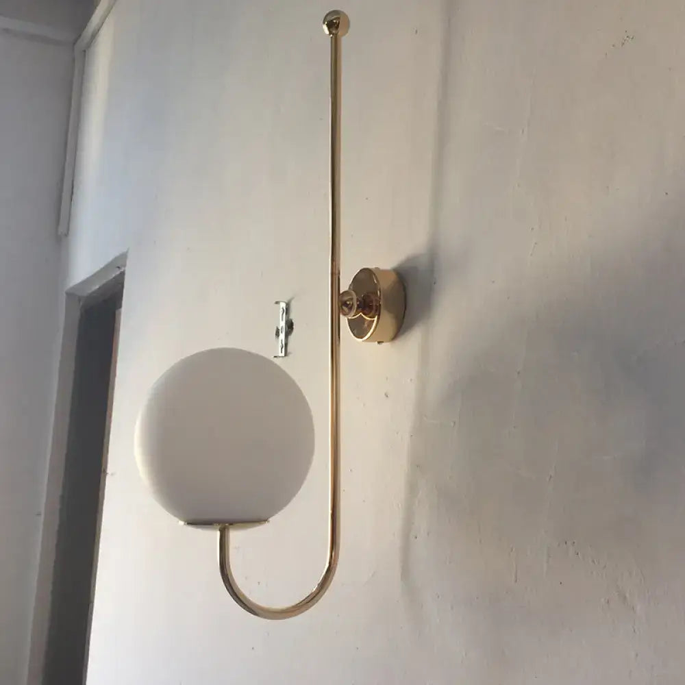 Gold gooseneck wall sconce with round frosted glass shade by Decorbites on Tampa Home & Garden Store