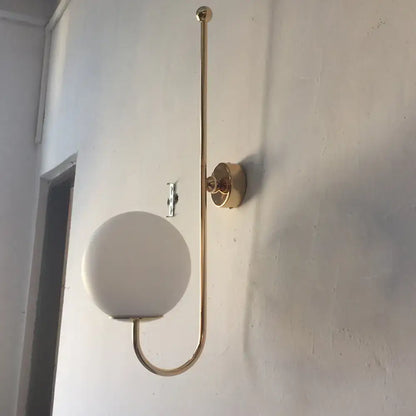Gold gooseneck wall sconce with round frosted glass shade by Decorbites on Tampa Home & Garden Store