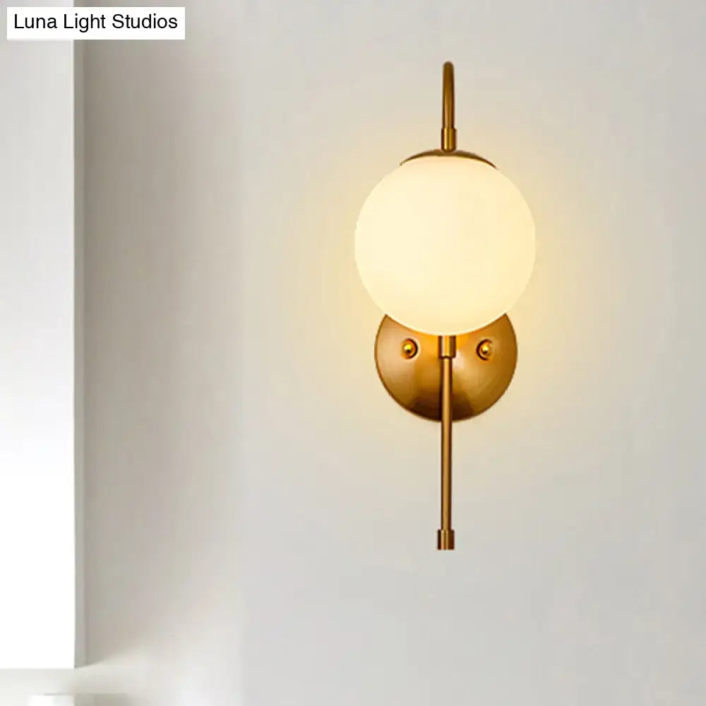 Gold Gooseneck wall sconce with frosted glass globe on Tampa Home & Garden Store