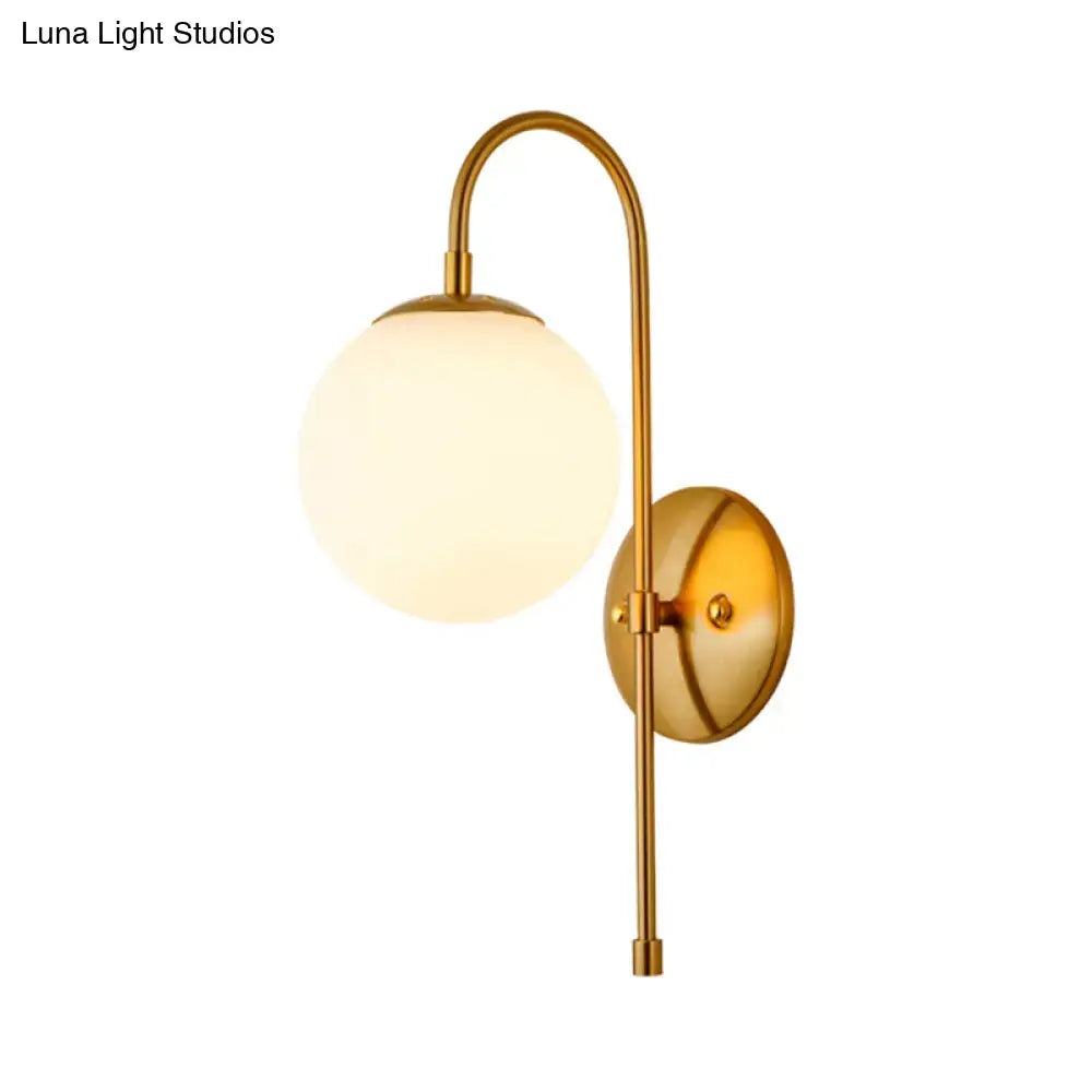 Gold gooseneck wall sconce by Decorbites with frosted glass globe and brass finish on Tampa Home & Garden Store