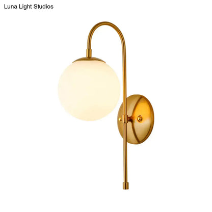 Gold gooseneck wall sconce by Decorbites with frosted glass globe and brass finish on Tampa Home & Garden Store