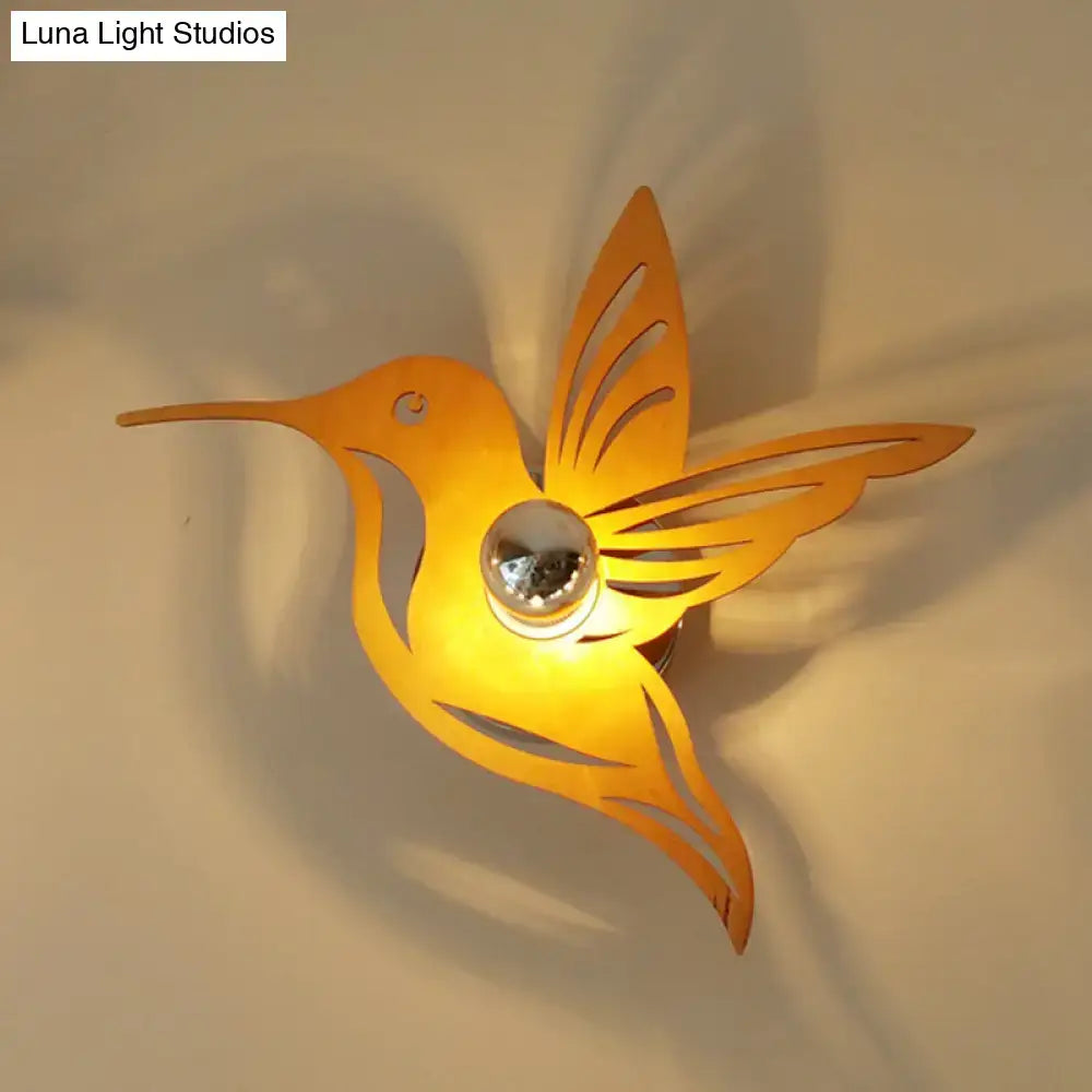 Beige Hummingbird Wall Sconce with cutout wings and warm glow Decorbites on Tampa Home & Garden Store