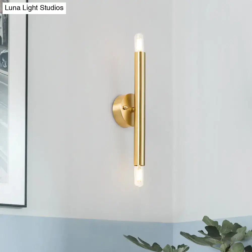 Gold tubular wall sconce by Decorbites, vertical brass tube with dual bulbs, wall-mounted on Tampa Home & Garden Store
