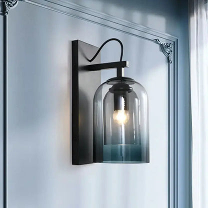 Modern gradient glass sconce with black metal backplate and blue shade for bedroom lighting on Tampa Home & Garden Store