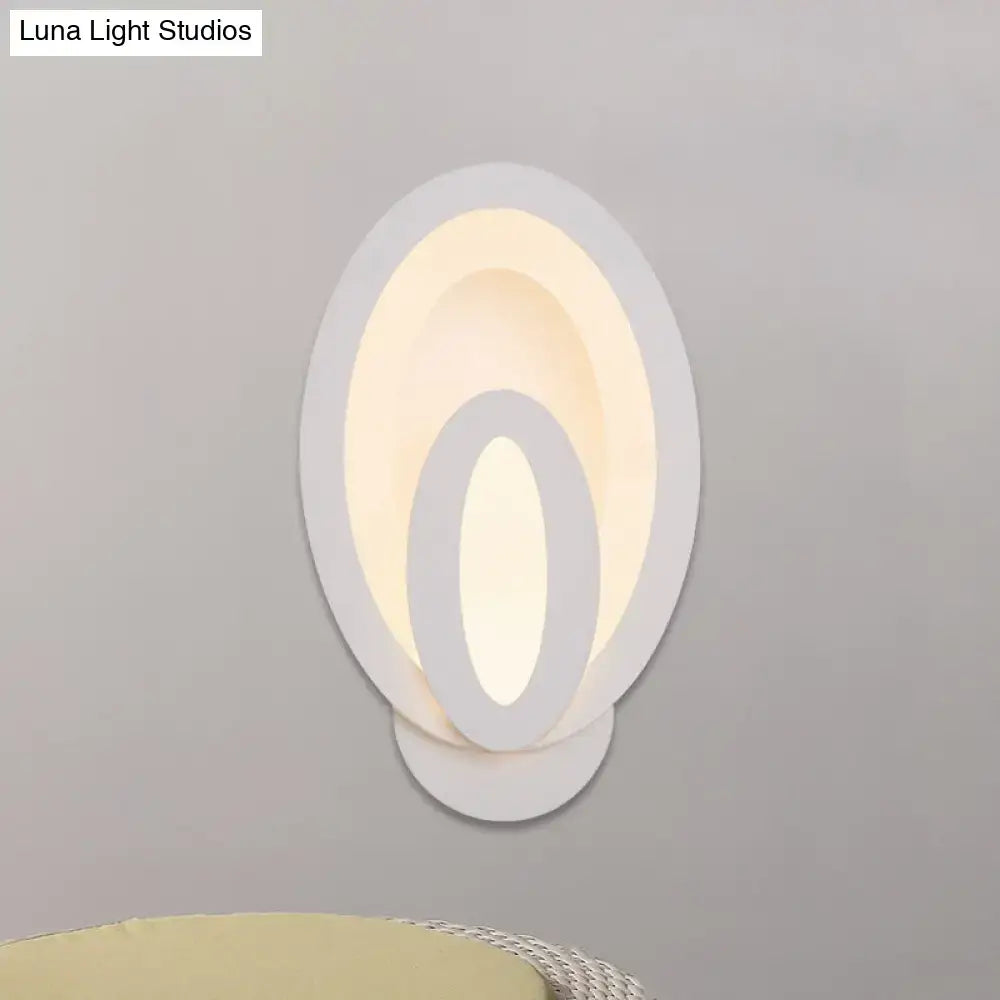 Gray layered LED sconce by Decorbites with nested circular rings on wall, ambient light on Tampa Home & Garden Store