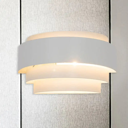 White tiered wall sconce with three curved panels, warm glow Decorbites on Tampa Home & Garden Store