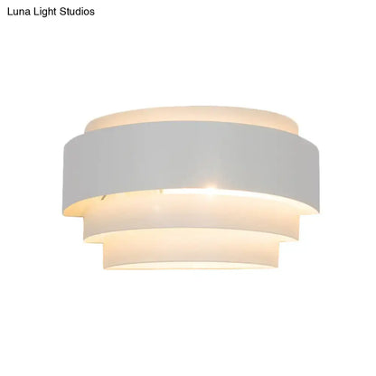 White tiered wall sconce with layered circular shade, warm ambient light Decorbites on Tampa Home & Garden Store