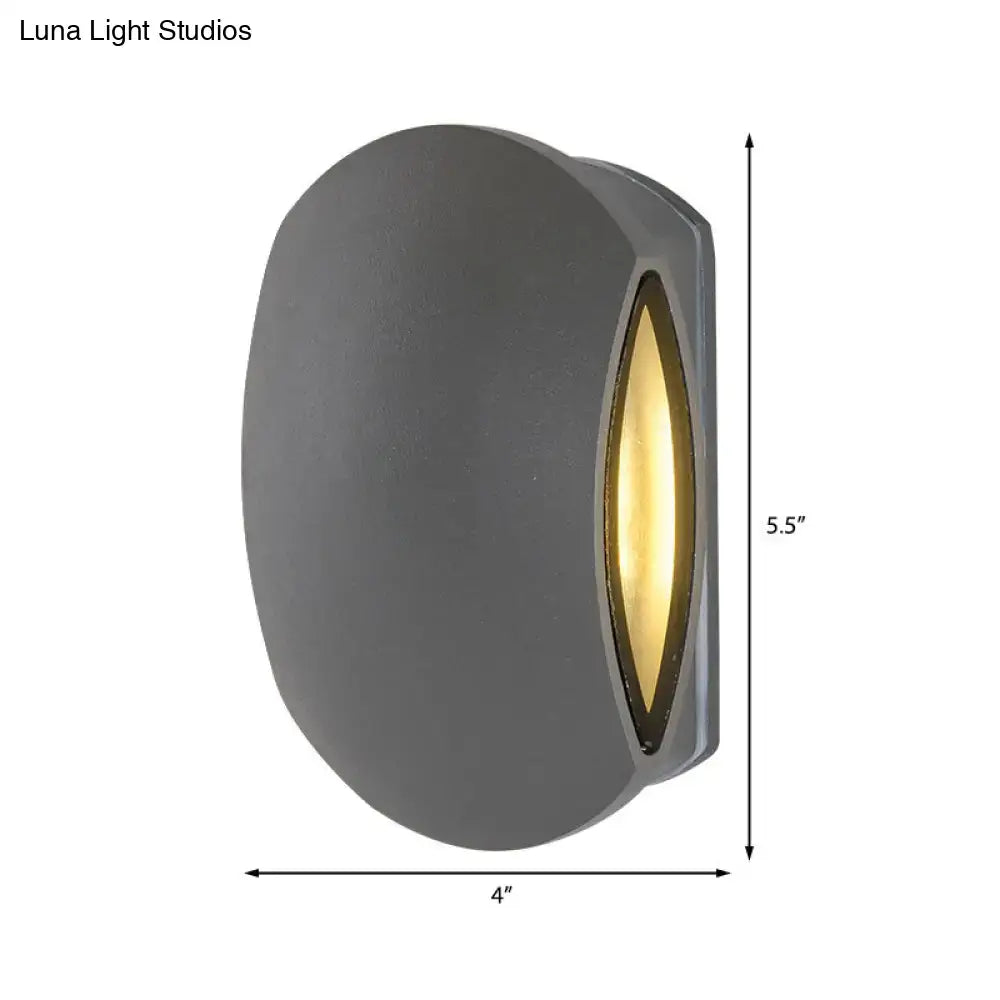 Black Oval Outdoor Sconce Decorbites in dark gray metal with warm amber glow on Tampa Home & Garden Store