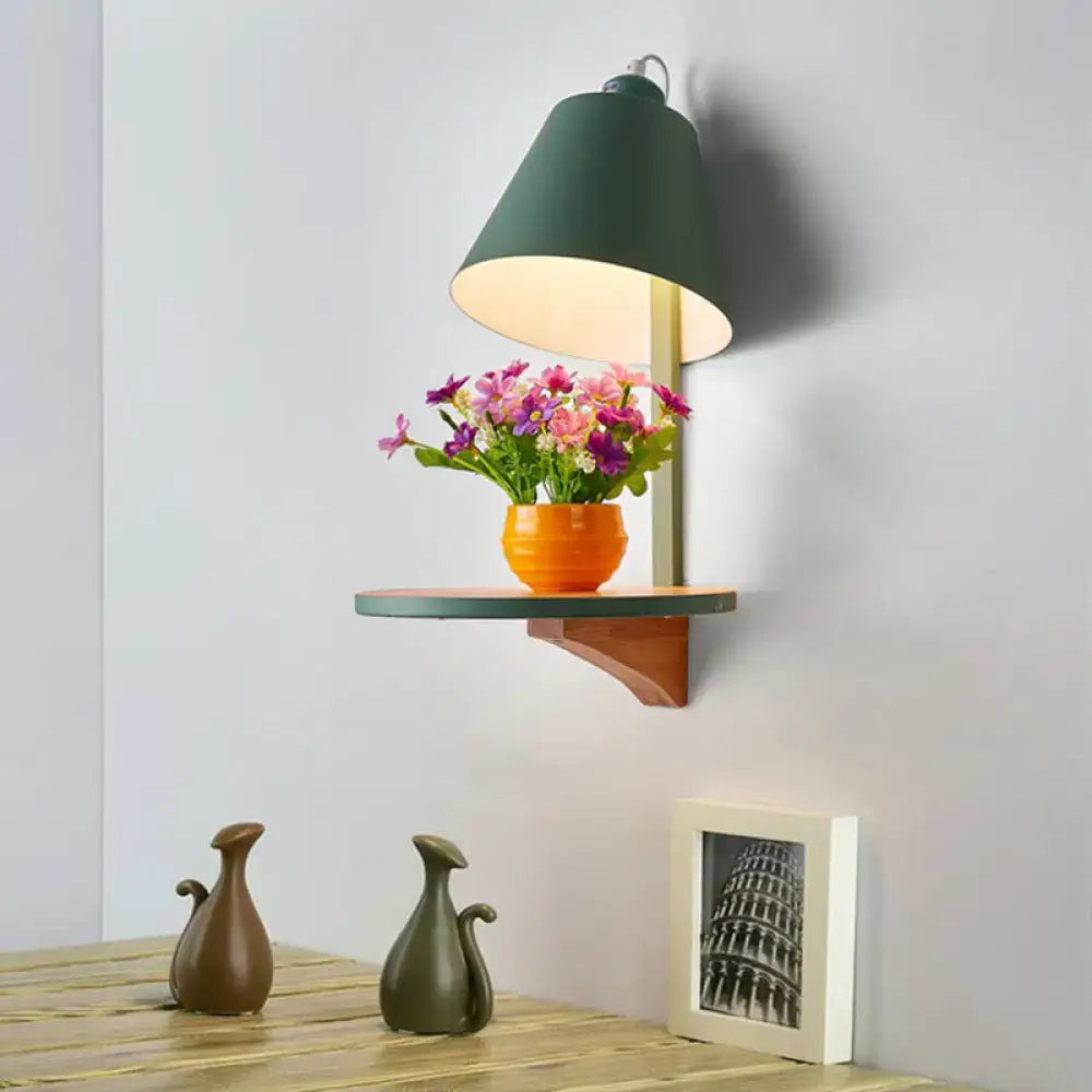 Gray tapered shade sconce by Decorbites on wall above a shelf with orange vase and flowers on Tampa Home & Garden Store