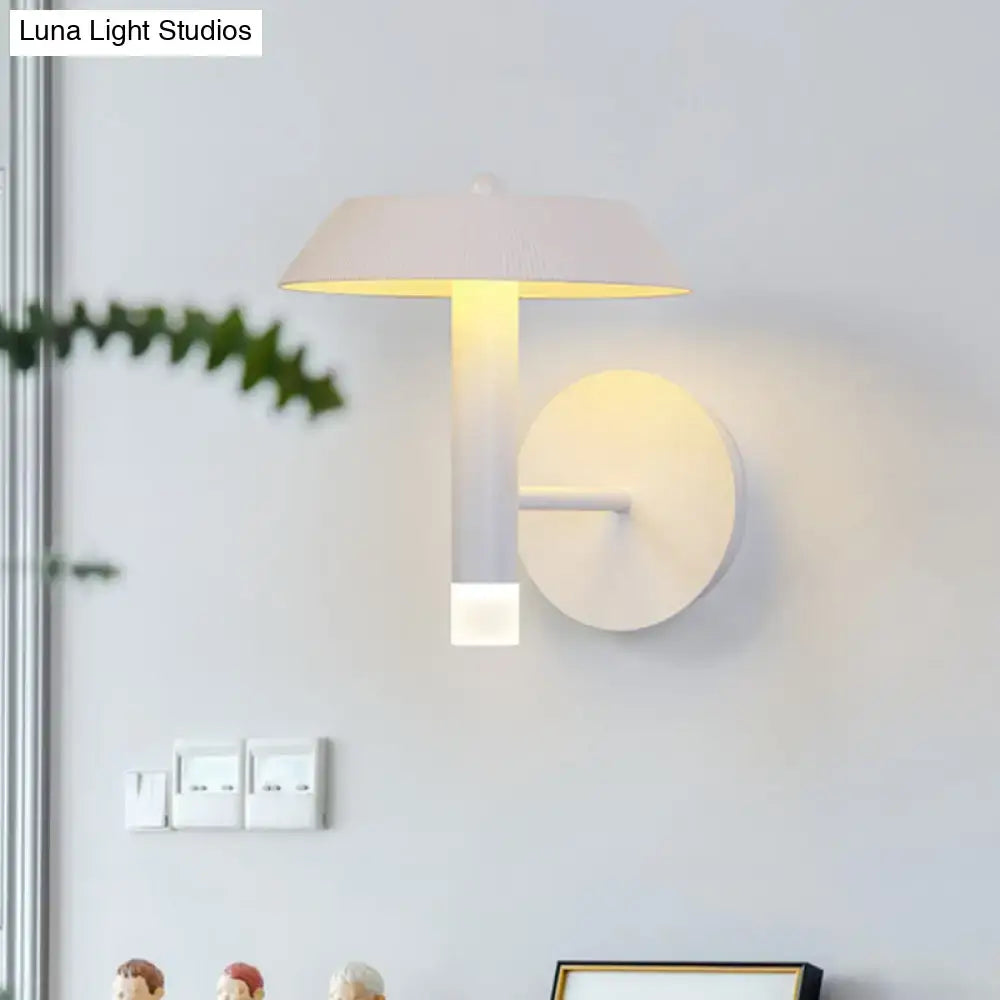 Decorbites gray industrial wall sconce with round backplate and vertical arm, warm glow on Tampa Home & Garden Store