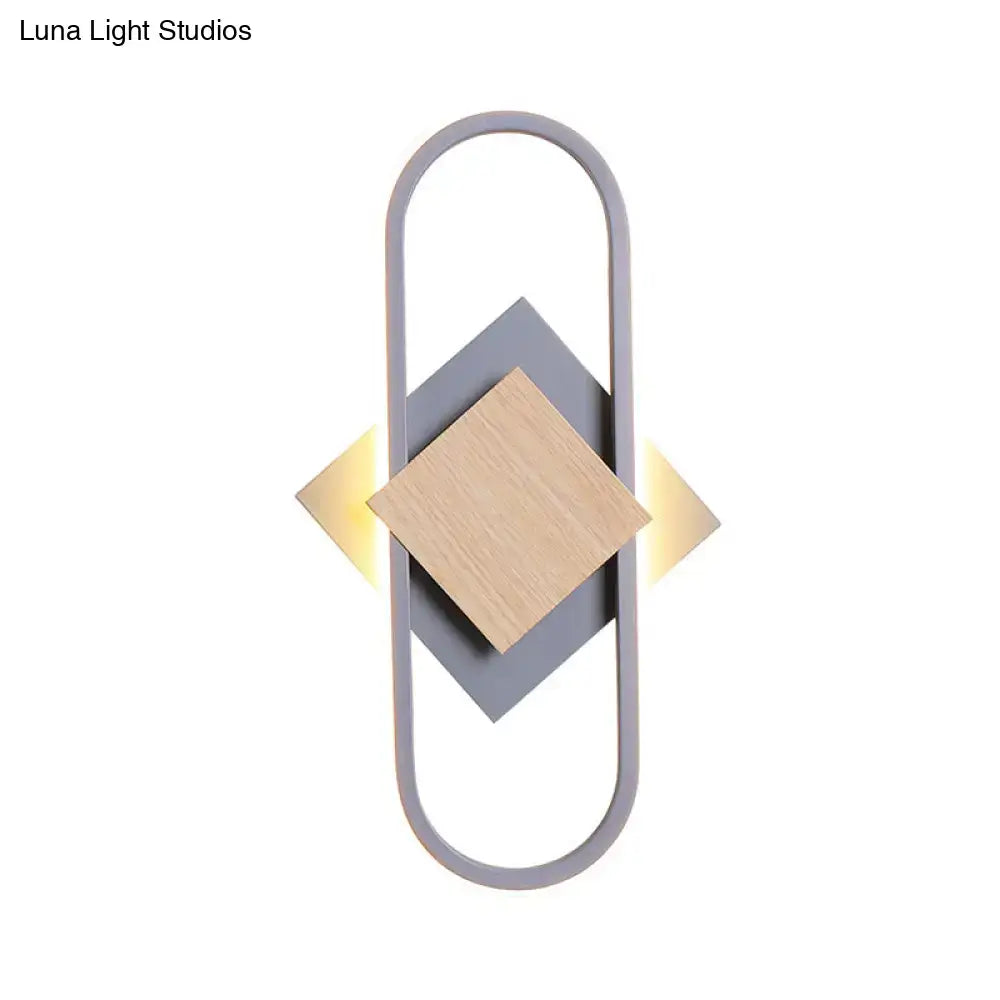 Gray wood geometric sconce with oval gray frame and wood diamond centerpiece, warm light on Tampa Home & Garden Store