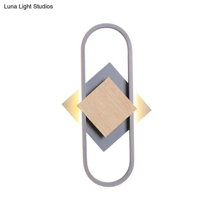 Gray wood geometric sconce with oval gray frame and wood diamond centerpiece, warm light on Tampa Home & Garden Store