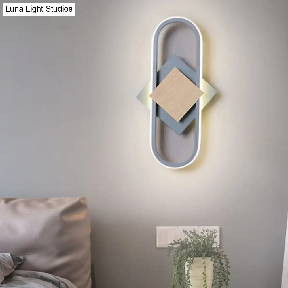 Gray wood geometric wall sconce with oval frame and layered blue and beige diamonds on Tampa Home & Garden Store
