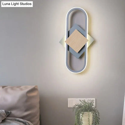 Gray wood geometric wall sconce with oval frame and layered blue and beige diamonds on Tampa Home & Garden Store