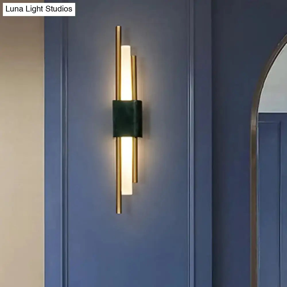 Green marble wall sconce with gold metal accents and warm light on Tampa Home & Garden Store