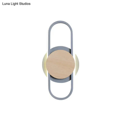 Grey wood LED wall sconce by Decorbites with central natural wood circle in a grey loop frame on Tampa Home & Garden Store