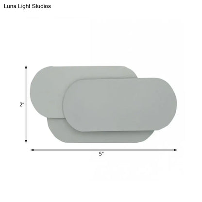 Grey oval metal sconce by Decorbites; slim modern wall light, 5in wide x 2in high on Tampa Home & Garden Store