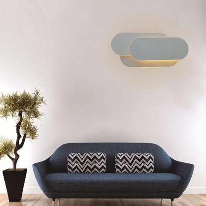 Grey oval metal sconce by Decorbites emitting warm light home & garden lighting on Tampa Home & Garden Store