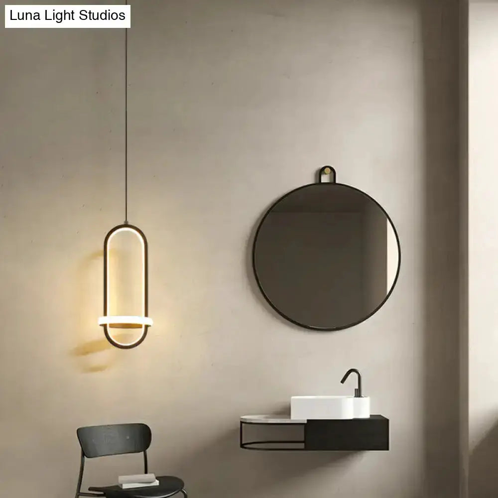 Modern halo ring pendant light in black metal with warm LED glow ceiling hung on Tampa Home & Garden Store