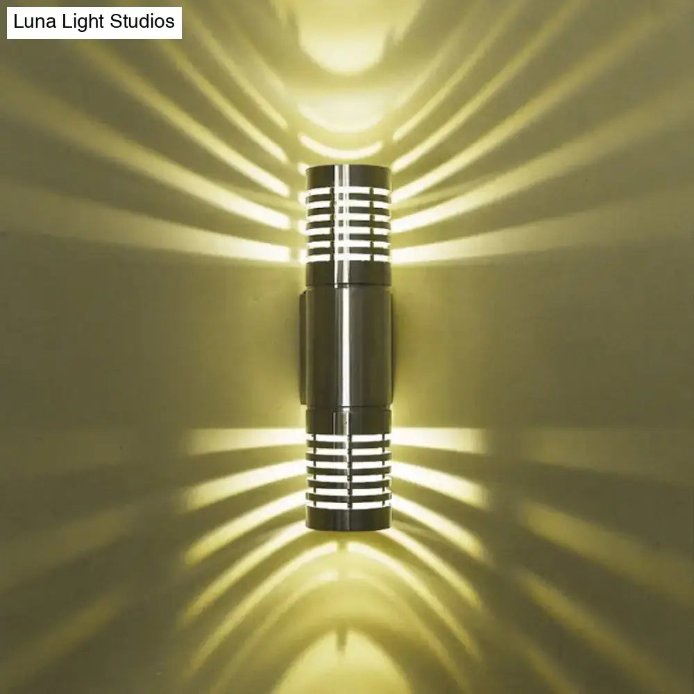 Chrome industrial wall sconce Decorbites ribbed cylindrical metal body warm light on wall on Tampa Home & Garden Store