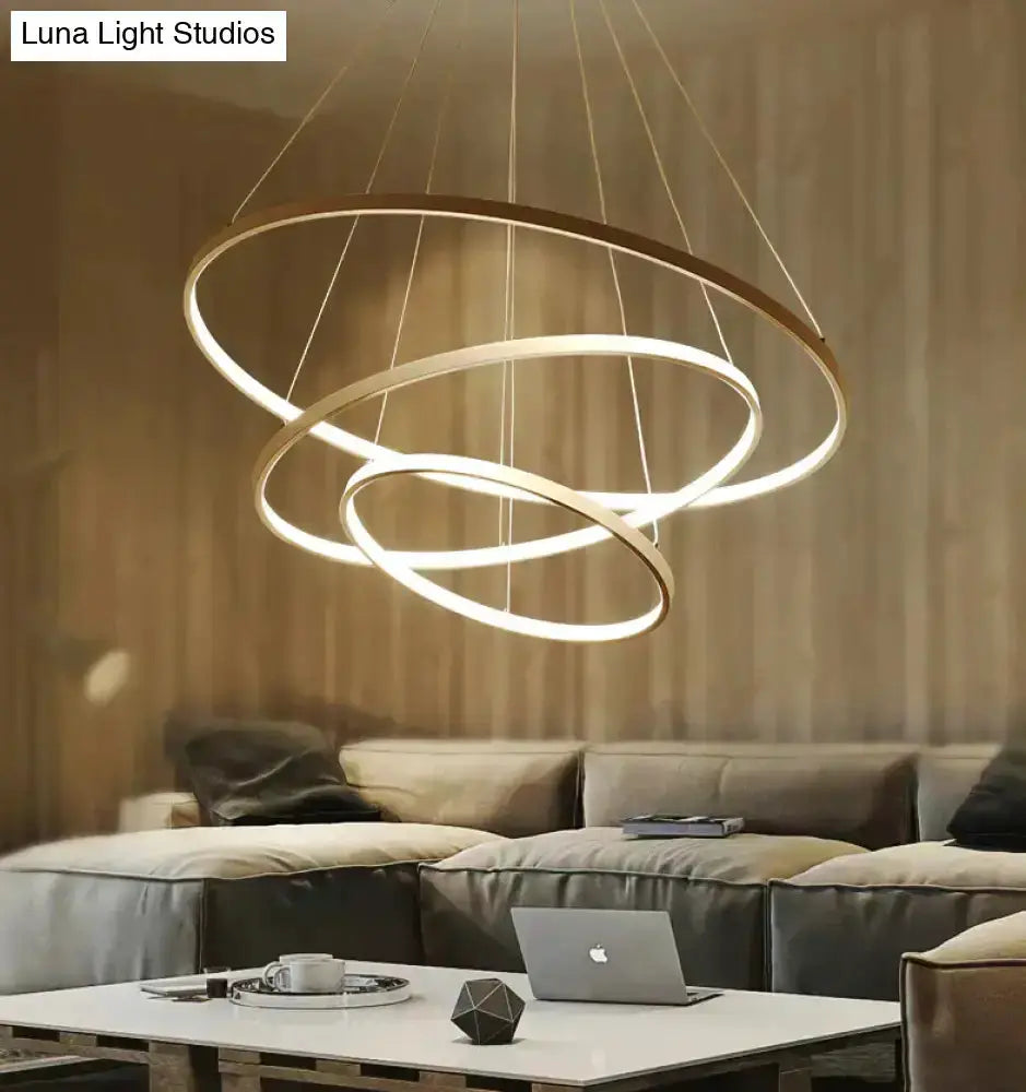 Pendant light with modern interlocking gold rings, LED glow for dining room on Tampa Home & Garden Store