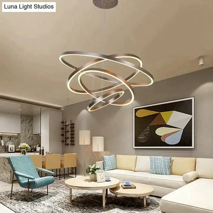 Pendant light modern interlocking ring LED fixture with warm glow in living room on Tampa Home & Garden Store