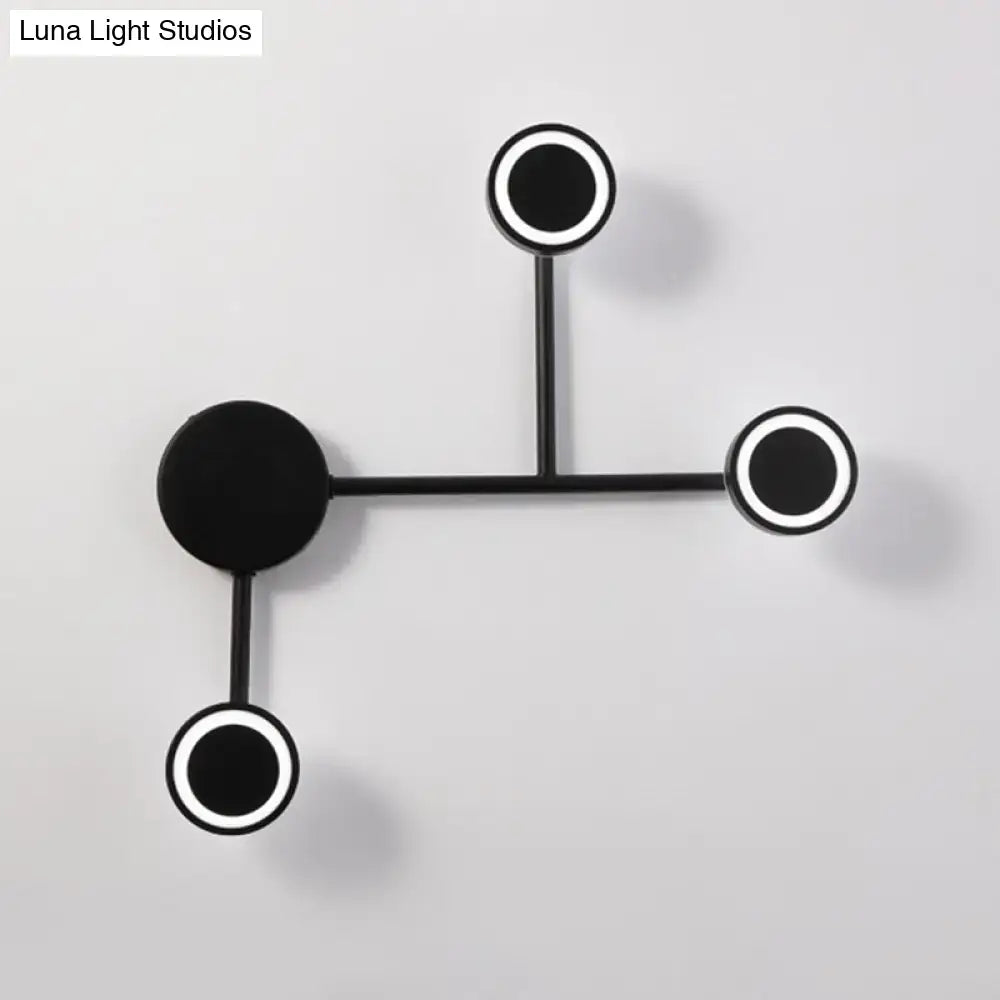Black industrial warm LED wall sconce with three circular ring lights on a metal frame on Tampa Home & Garden Store