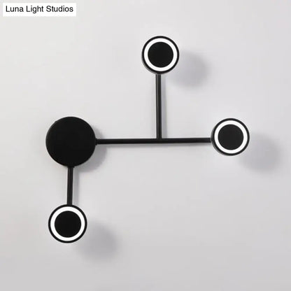 Black industrial warm LED wall sconce with three circular ring lights on a metal frame on Tampa Home & Garden Store