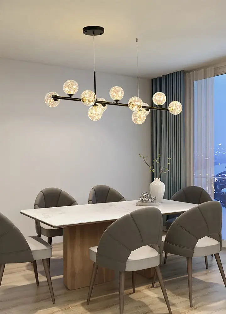 Black Gold Adjustable Ring Chandelier for Dining with glass orb bulbs over marble dining table on Tampa Home & Garden Store