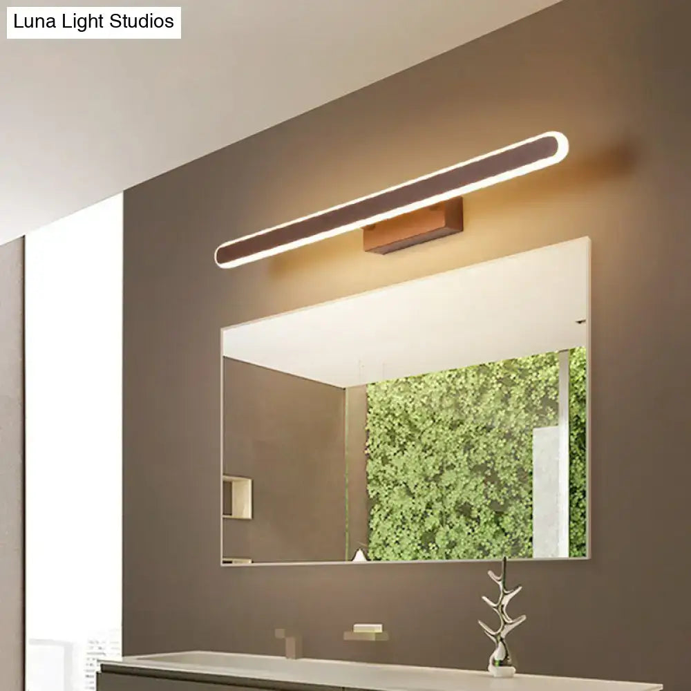 Coffee Linear LED Sconce by Decorbites, warm bronze finish above bathroom mirror on Tampa Home & Garden Store