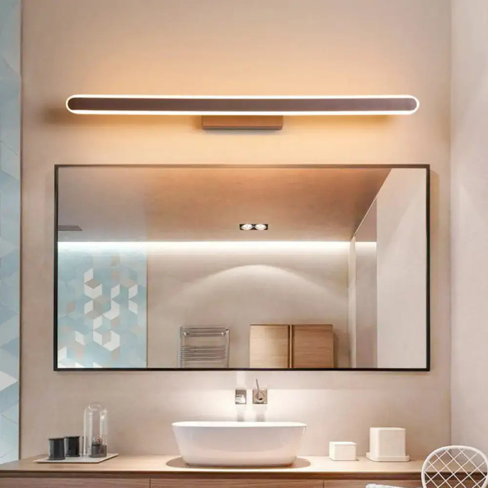 Decorbites Coffee Linear LED Sconce warm white glow above a large bathroom mirror on Tampa Home & Garden Store