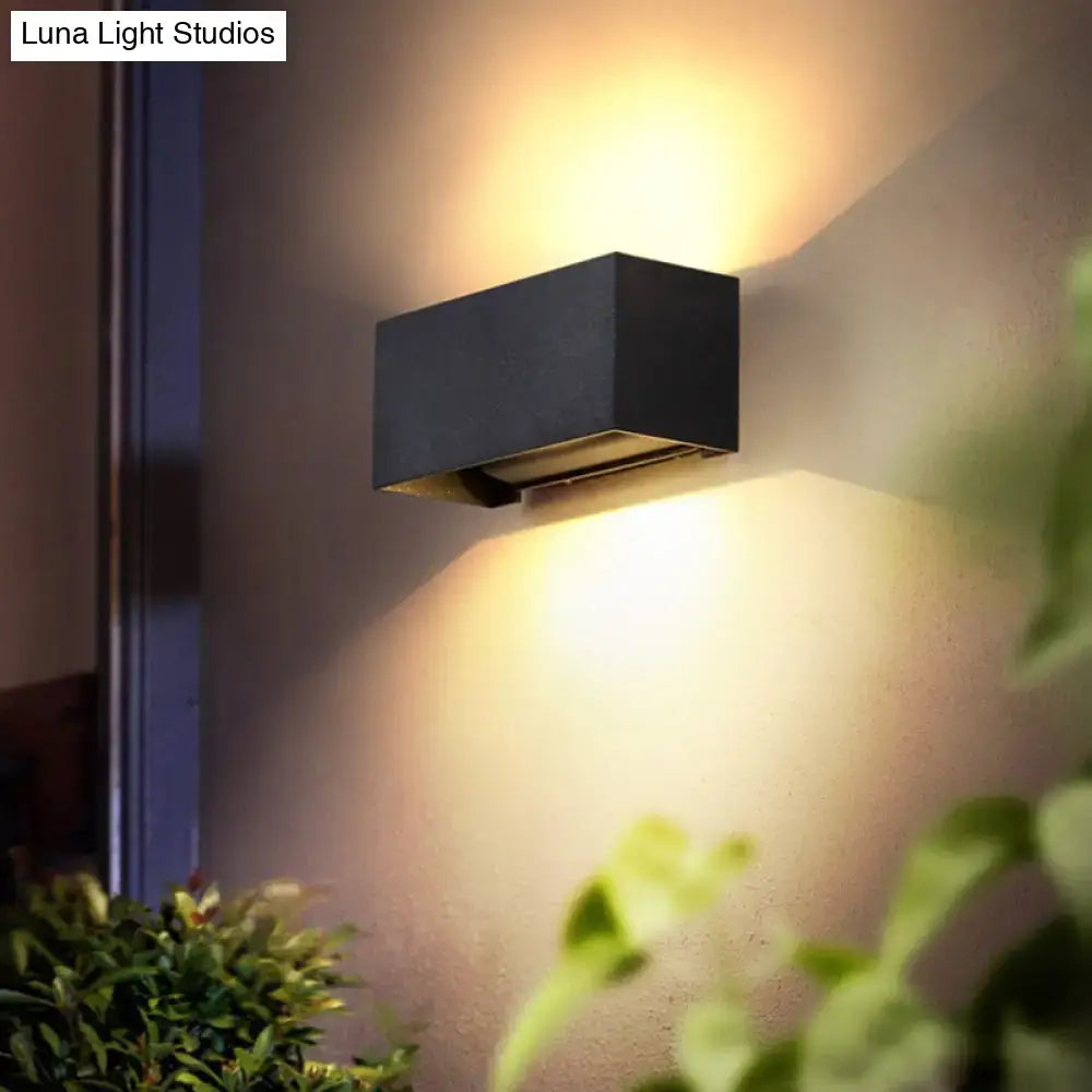 Decorbites black rectangle wall sconce, modern outdoor wall light emits warm glow on wall on Tampa Home & Garden Store