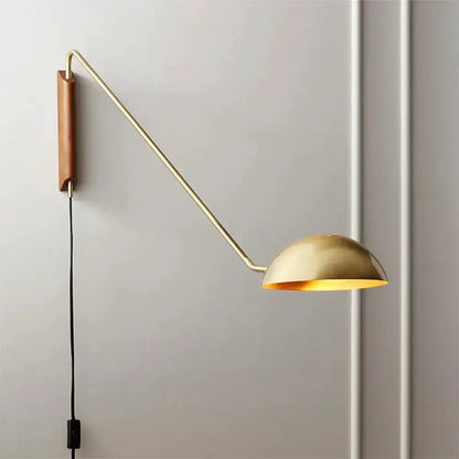 Brass-toned swing-arm bedside wall lamp with dome shade and wood mount on Tampa Home & Garden Store