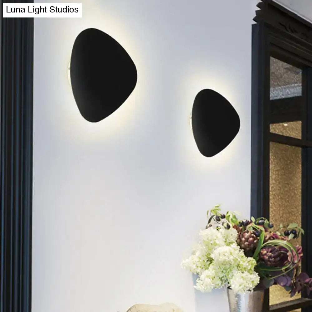 Black Triangle 10-Inch Wall Lamp pair, matte-black triangular wall sconces with soft glow on Tampa Home & Garden Store