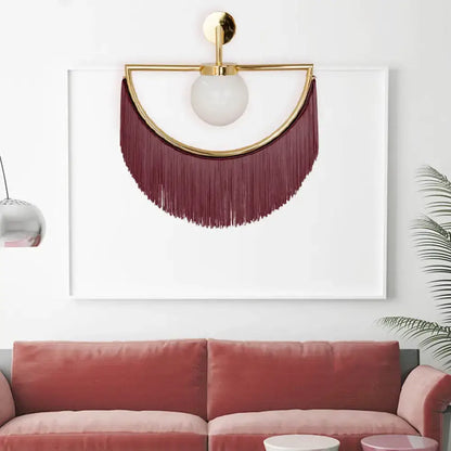 White glass wall sconce with gold half-ring and burgundy tassel fringe by Decorbites on Tampa Home & Garden Store