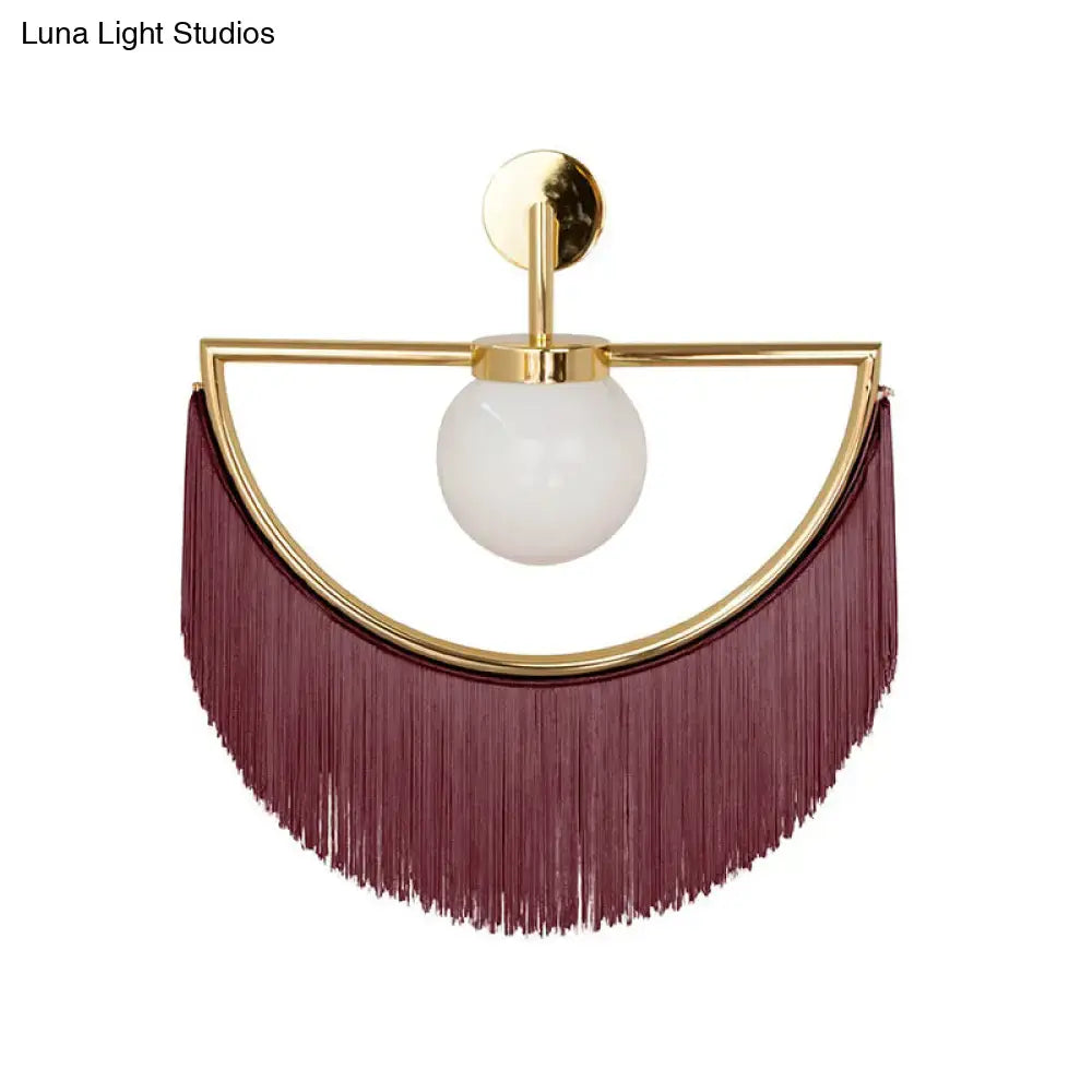 Decorbites white glass wall sconce with gold semicircular frame and burgundy tassel fringe on Tampa Home & Garden Store