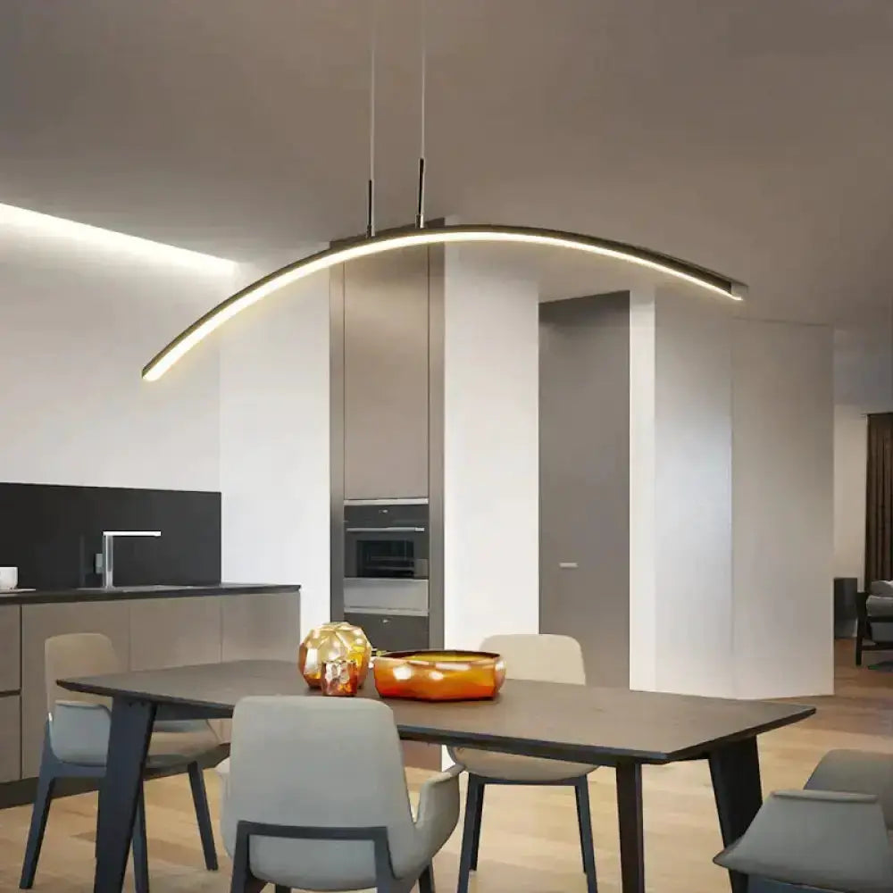 Pendant light Decorbites arc-shaped metallic LED fixture over dining table on Tampa Home & Garden Store