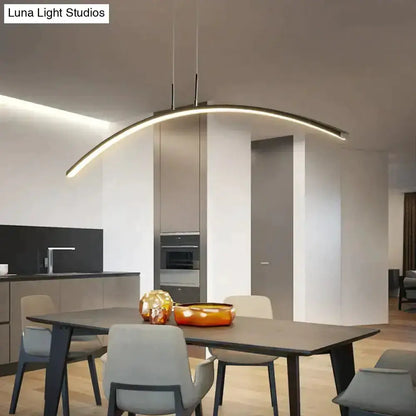 Pendant light, modern metallic arc LED fixture by Decorbites over a dining table on Tampa Home & Garden Store