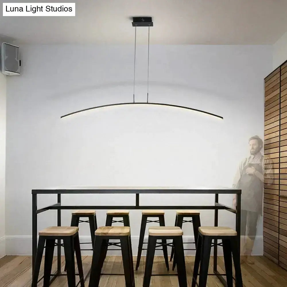 Pendant light Decorbites arc LED over black dining table with six light wood stools on Tampa Home & Garden Store
