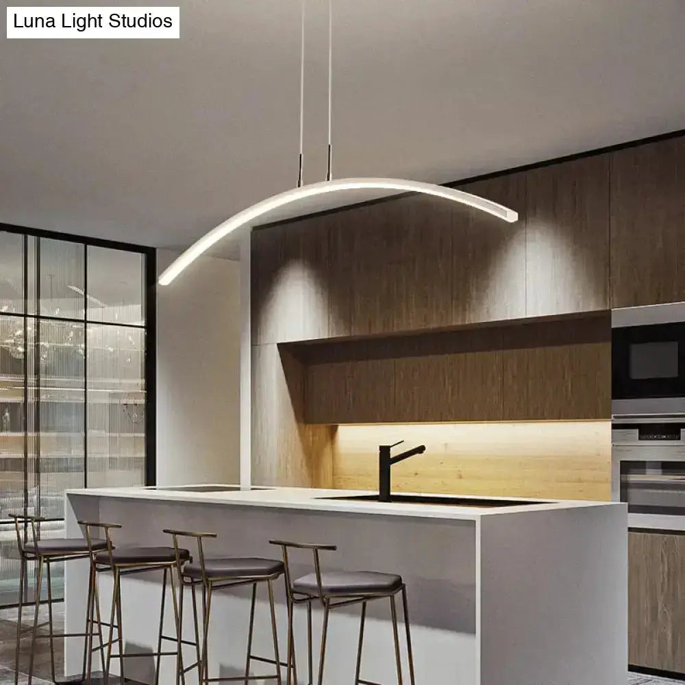 Pendant light: modern metallic arc LED pendant by Decorbites over a white kitchen island on Tampa Home & Garden Store