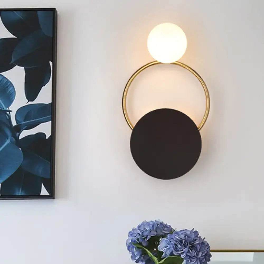 Black Gold Wall Light Sconce with a gold ring, black circular disc shade and white globe on Tampa Home & Garden Store