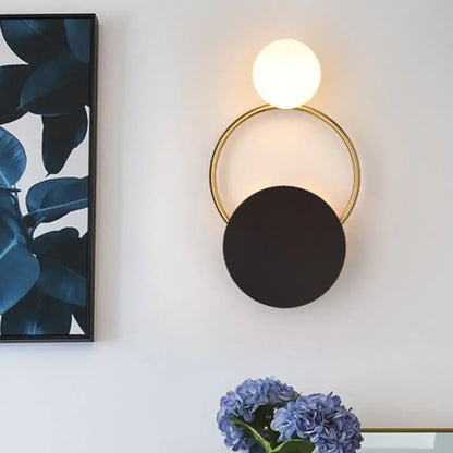 Black Gold Wall Light Sconce with a gold ring, black circular disc shade and white globe on Tampa Home & Garden Store