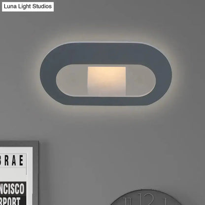 Modern minimalist black and grey oval shade wall lamp for bedroom lighting with warm glow on Tampa Home & Garden Store